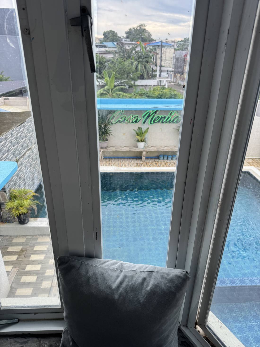 The pool seen through a bedroom window